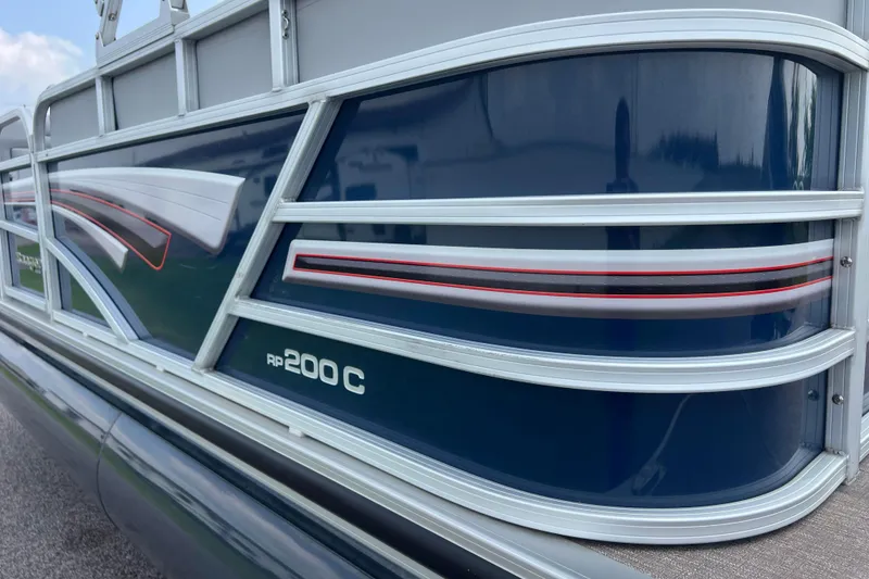 Slide: The Image of 2019 Ranger Reata 200C pontoon boat with sleek blue and silver design. - 43