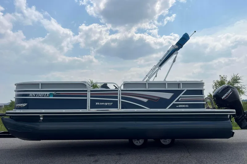 Slide: The Image of 2019 Ranger Reata 200C pontoon boat with Mercury outboard motor on a sunny day. - 5