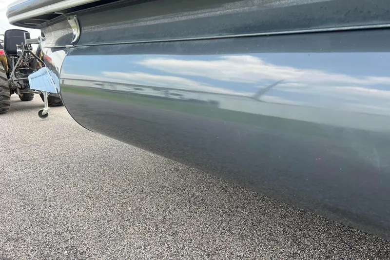 Slide: The Image of 2019 Ranger Reata 200C boat hull reflecting sky and surroundings on pavement. - 54