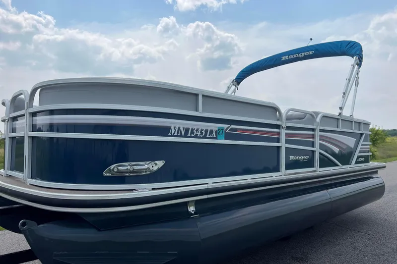 Slide: The Image of 2019 Ranger Reata 200C pontoon boat with blue canopy on a sunny day. - 6