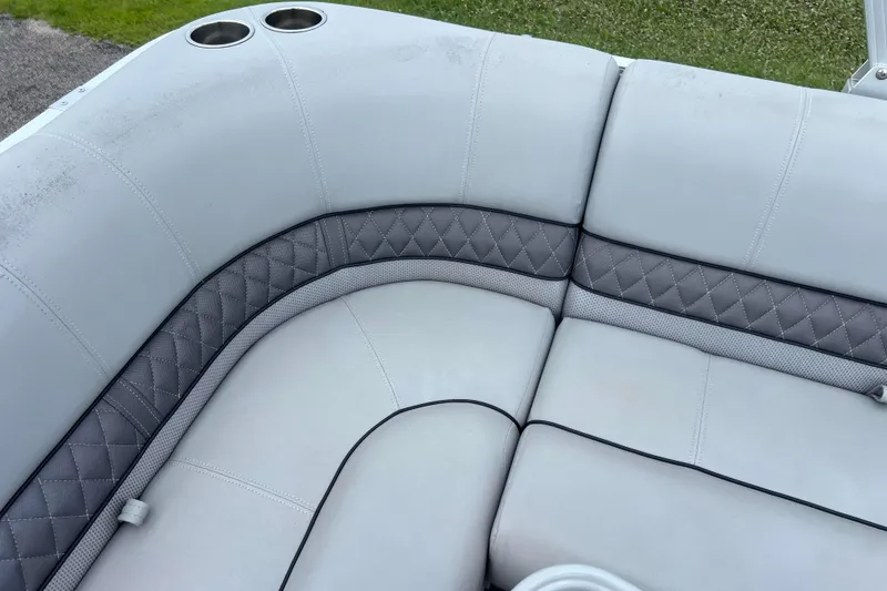 Slide: The Image of 2019 Ranger Reata 200C boat interior with gray quilted seating and cup holders. - 9