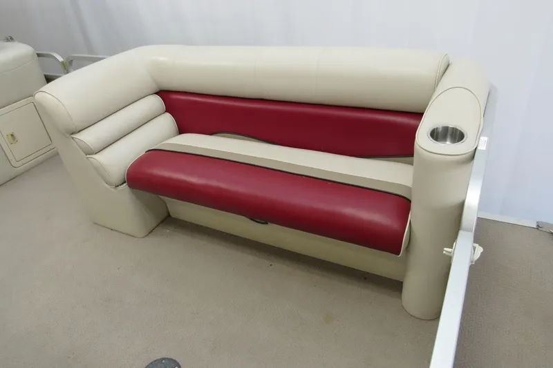 Slide: The Image of 2000 Sylvan Supreme LX boat seating with red and beige upholstery, featuring a built-in cup holder. - 4