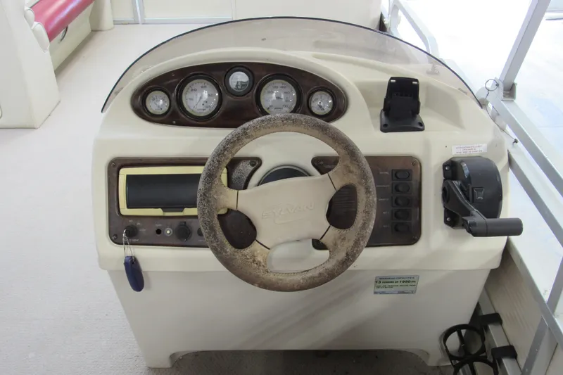 Slide: The Image of Steering console of a 2000 Sylvan Supreme LX boat with gauges and controls. - 7