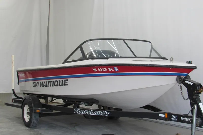 Slide: The Image of 1996 Nautique Ski 196 boat on ShoreLand'r trailer in indoor setting. - 1