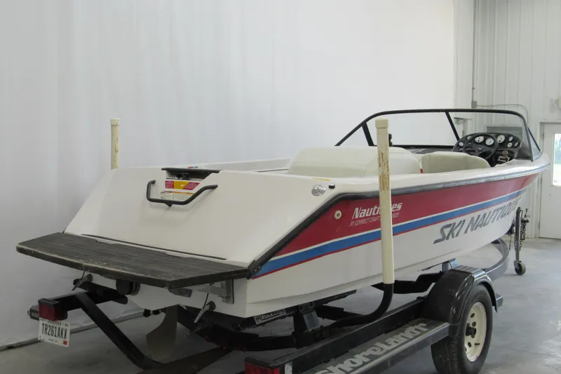 Slide: The Image of 1996 Nautique Ski 196 boat on trailer in indoor storage. - 2