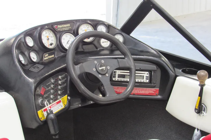Slide: The Image of 1996 Nautique Ski 196 dashboard with steering wheel, gauges, and controls. - 4