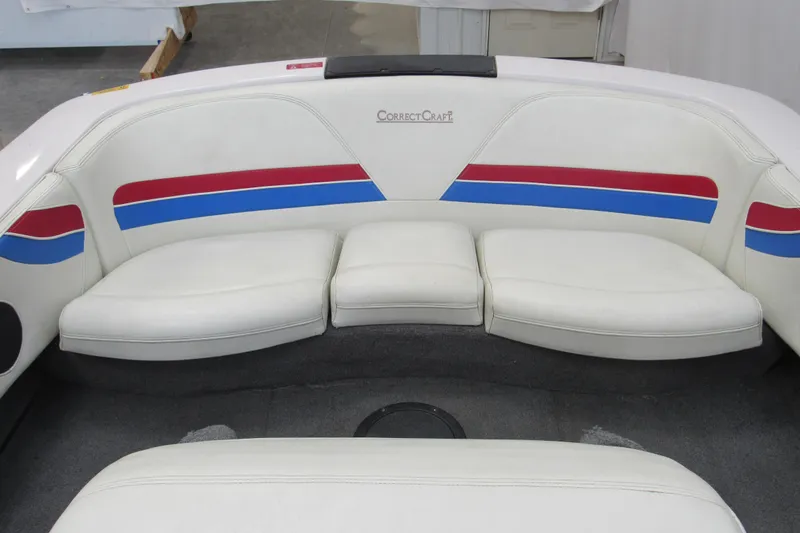 Slide: The Image of 1996 Nautique Ski 196 boat interior with white seating, red and blue accents. - 5