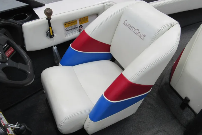Slide: The Image of 1996 Nautique Ski 196 boat interior with white, red, and blue seat upholstery. - 7