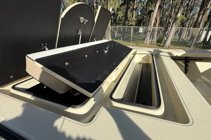 Slide: The Image of 2020 East Cape EVO X 18 boat storage compartments open, showcasing interior design. - 11