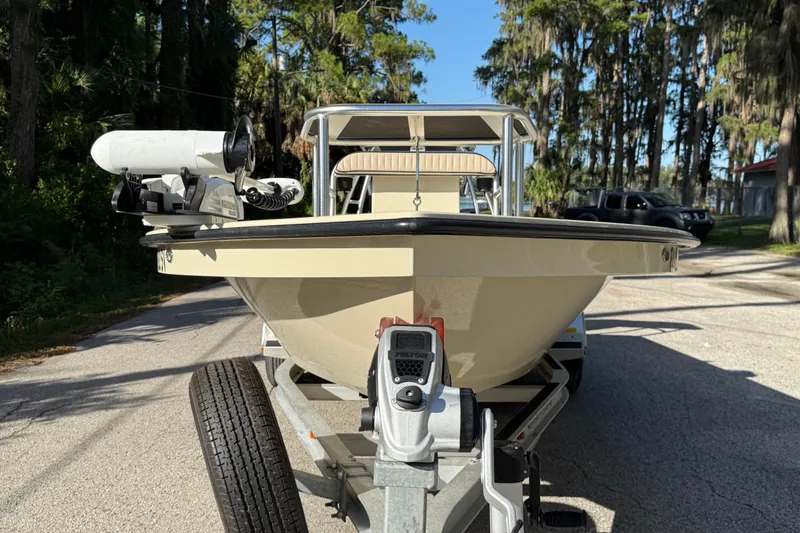 Slide: The Image of 2020 East Cape EVO X 18 boat on trailer, parked on a sunny road. - 2