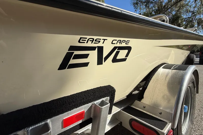 Slide: The Image of 2020 East Cape EVO X 18 boat on trailer, side view with logo. - 21