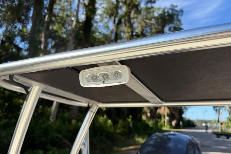 Slide: The Image of 2020 East Cape EVO X 18 boat T-top with mounted LED light, outdoor setting. - 23