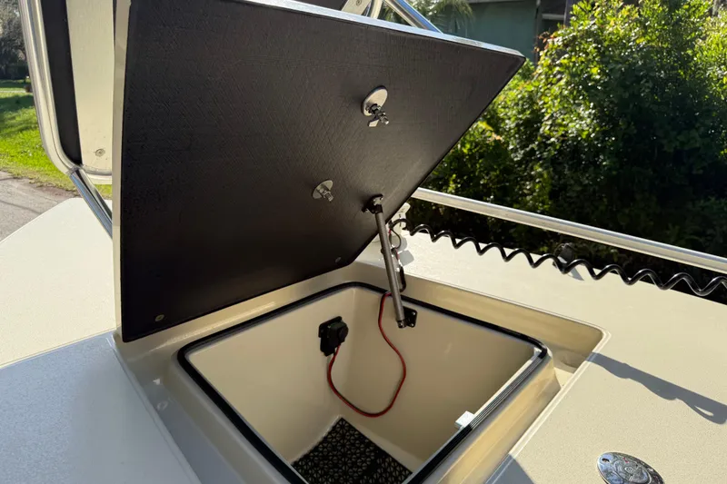 Slide: The Image of Open storage compartment on 2020 East Cape EVO X 18 boat, showing interior details. - 26