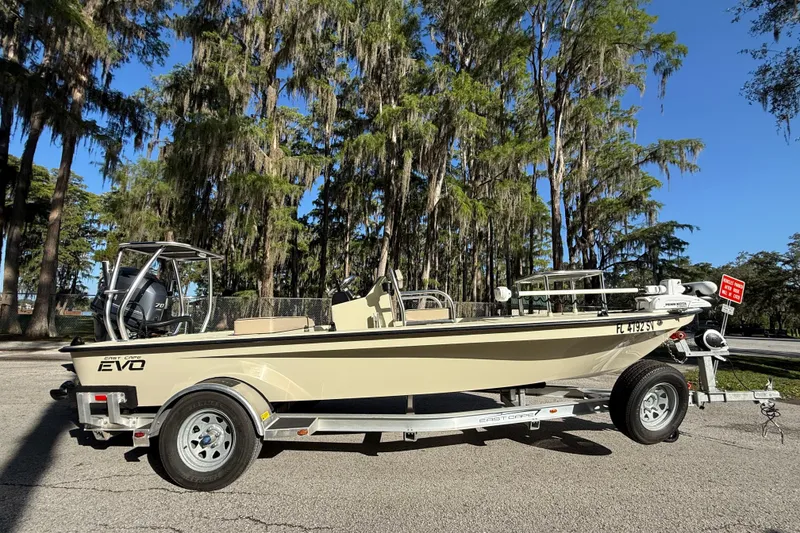 Slide: The Image of 2020 East Cape EVO X 18 boat on trailer, parked near trees. - 4
