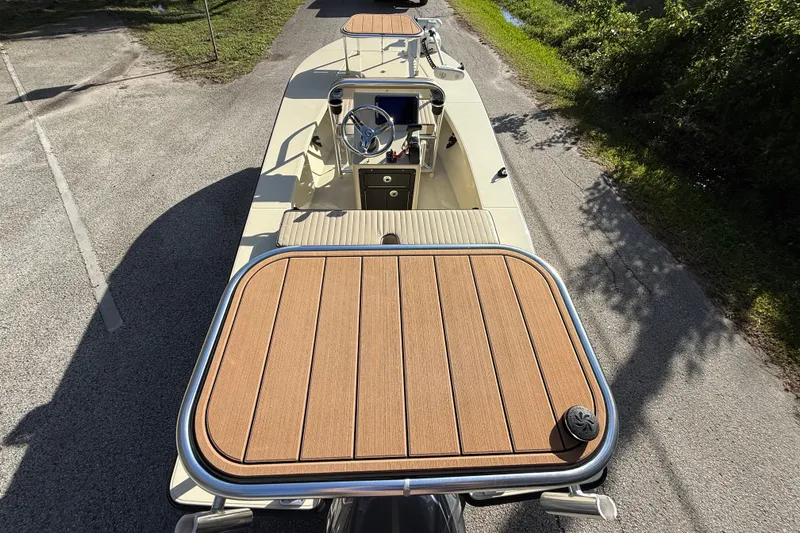 Slide: The Image of 2020 East Cape EVO X 18 boat with wooden deck, steering console, and sleek design. - 7