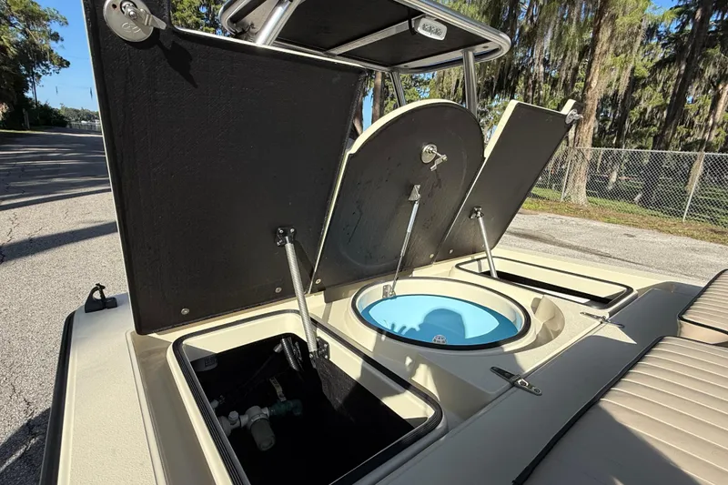Slide: The Image of 2020 East Cape EVO X 18 boat with open storage compartments and livewell. - 9