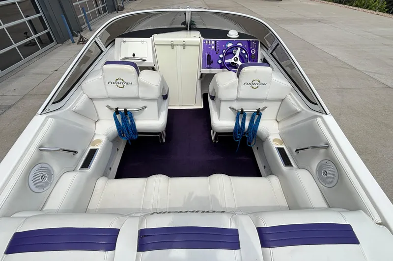 Slide: The Image of 2003 Fountain 29 Fever boat interior with white seating and purple accents. - 13