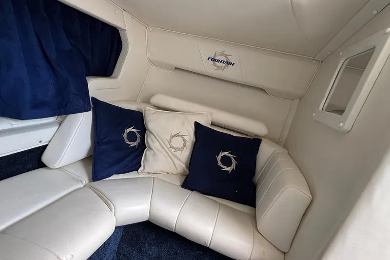 Slide: The Image of Interior of 2003 Fountain 29 Fever boat with white seating and decorative pillows. - 23