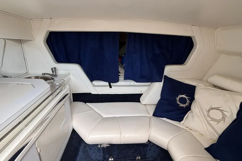 Slide: The Image of Interior of 2003 Fountain 29 Fever boat with white seating and blue curtains. - 24