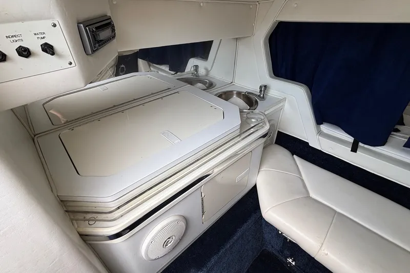 Slide: The Image of 2003 Fountain 29 Fever boat interior with kitchenette, sink, and seating area. - 25