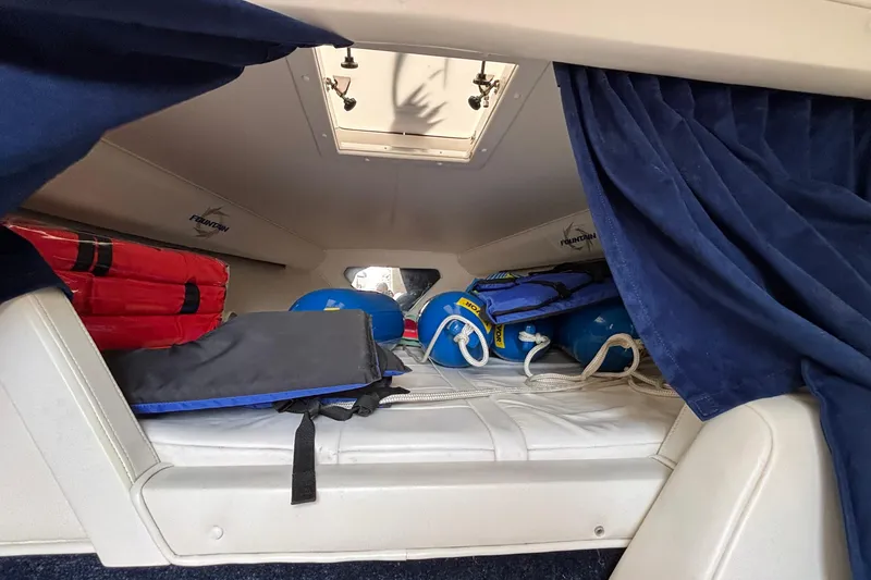 Slide: The Image of Interior cabin of 2003 Fountain 29 Fever boat with life jackets and equipment. - 26