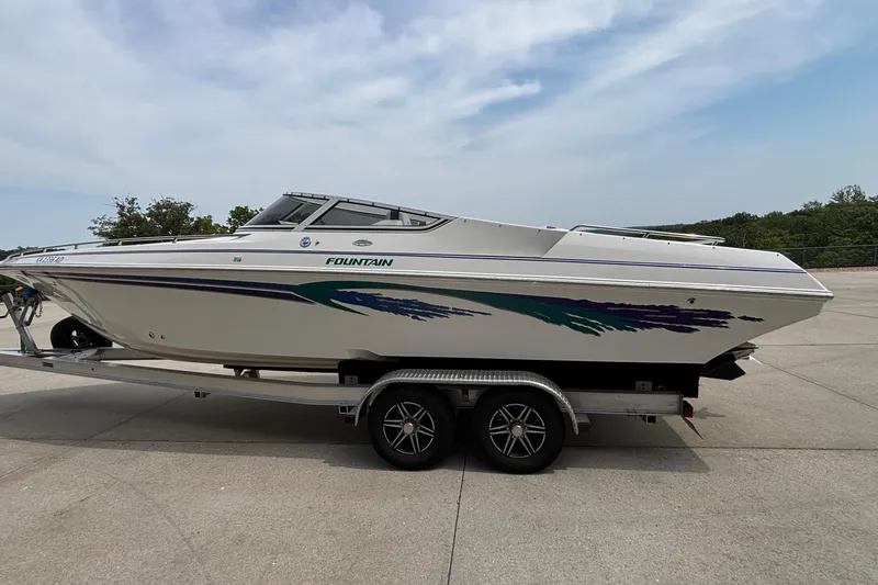 Slide: The Image of 2003 Fountain 29 Fever speedboat on trailer, featuring sleek design and vibrant graphics. - 3