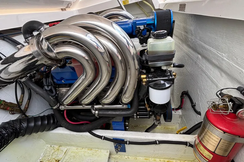 Slide: The Image of Engine compartment of a 2003 Fountain 29 Fever boat with polished exhaust headers. - 31