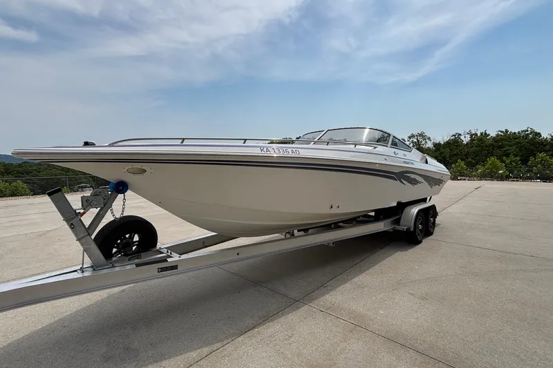 Slide: The Image of 2003 Fountain 29 Fever speedboat on trailer, parked outdoors under a clear sky. - 4