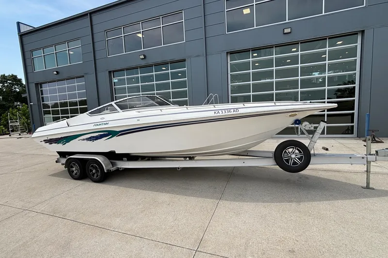 Slide: The Image of 2003 Fountain 29 Fever boat on trailer, parked outside a modern building. - 6