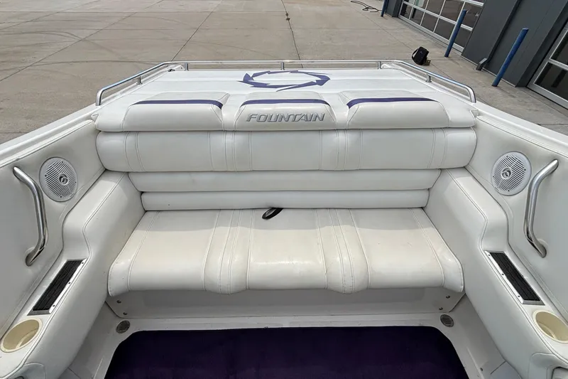 Slide: The Image of 2003 Fountain 29 Fever boat interior with white seating and built-in speakers. - 7