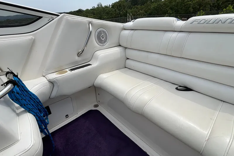 Slide: The Image of Interior of 2003 Fountain 29 Fever boat with white leather seating and blue rope. - 9