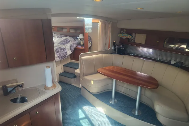 Slide: The Image of Interior of 2000 Cruisers Yachts 3575 Express with cozy seating and kitchenette. - 18