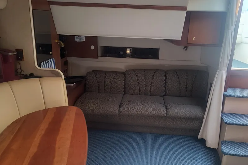 Slide: The Image of Interior of 2000 Cruisers Yachts 3575 Express with sofa, table, and stairs. - 22