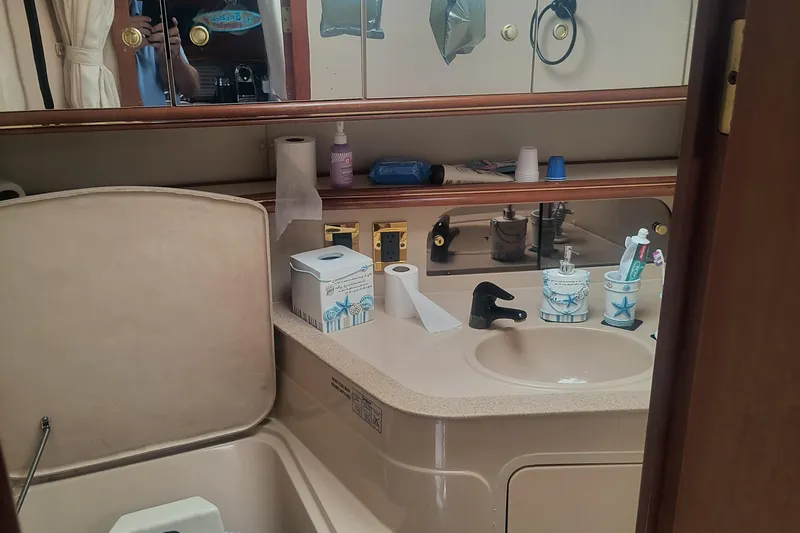 Slide: The Image of Bathroom interior of 2000 Cruisers Yachts 3575 Express with sink and toiletries. - 24