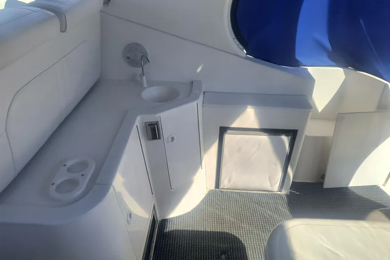 Slide: The Image of 2000 Cruisers Yachts 3575 Express interior with sink, storage, and seating area. - 15