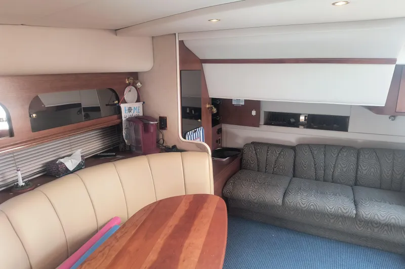 Slide: The Image of Interior of 2000 Cruisers Yachts 3575 Express with seating and wooden table. - 21