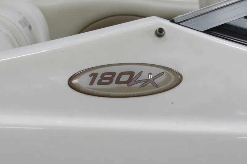 Slide: The Image of 2001 Stingray 180 LX boat emblem on white surface. - 11