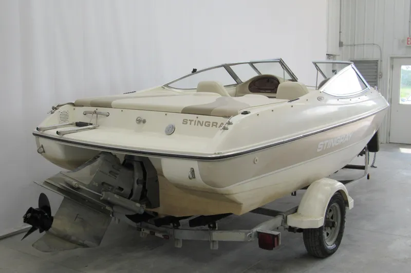 Slide: The Image of 2001 Stingray 180 LS/LX boat on trailer in a garage setting. - 2