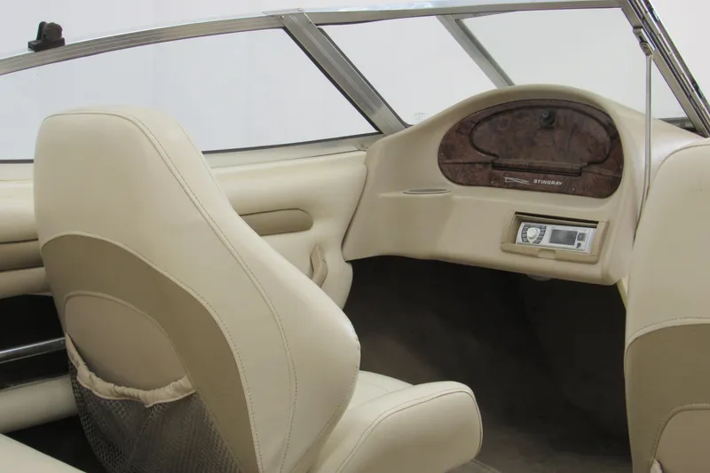 Slide: The Image of Interior of a 2001 Stingray 180 LS/LX boat with beige seating and dashboard. - 5