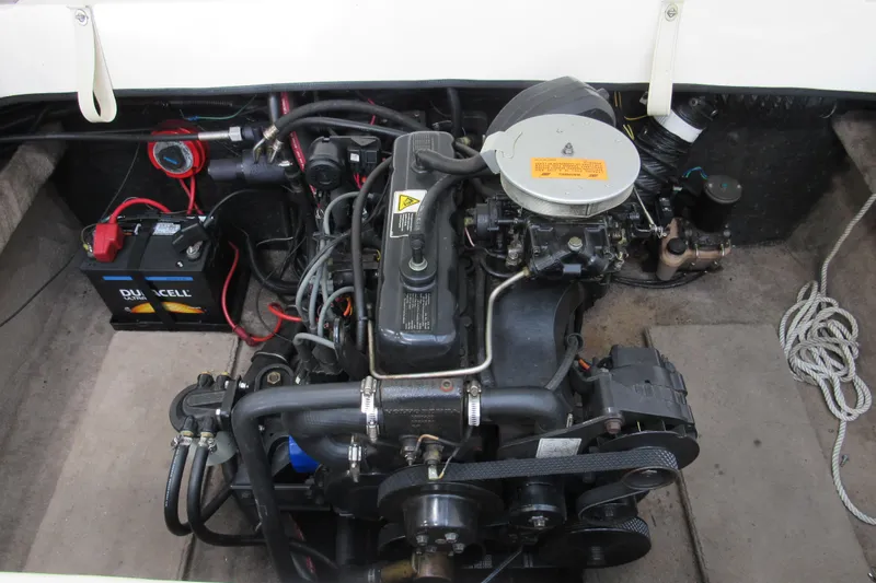 Slide: The Image of 2001 Stingray 180 LS/LX boat engine compartment with visible battery and wiring. - 8