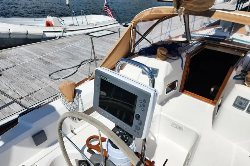 Slide: The Image of 2002 Sabre 362 sailboat cockpit with navigation equipment and docked dinghy. - 3