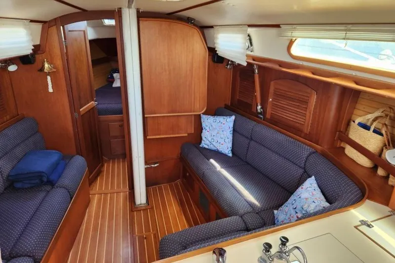 Slide: The Image of Interior of 2002 Sabre 362 sailboat with cozy seating and wooden finishes. - 4