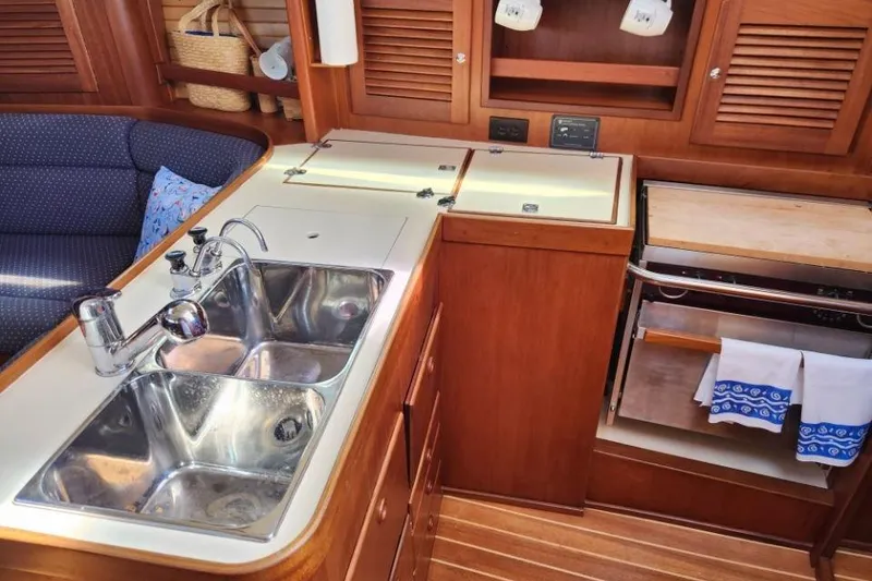Slide: The Image of 2002 Sabre 362 yacht interior kitchen with double sink and wooden cabinetry. - 5