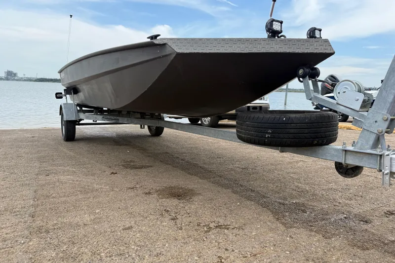 Slide: The Image of 2021 Alweld 1852 Invader boat on trailer by the water, side view. - 21