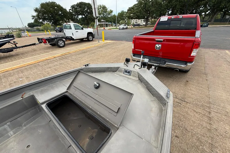 Slide: The Image of 2021 Alweld 1852 Invader boat hitched to a red pickup truck in a parking lot. - 22