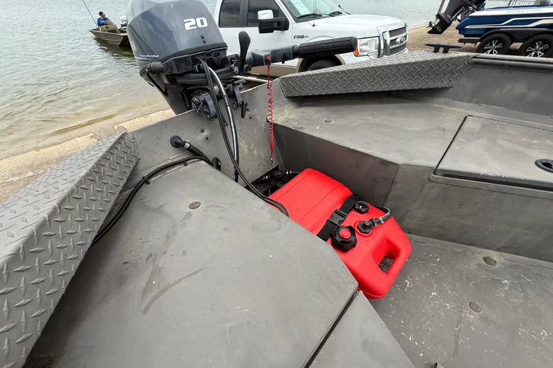 Slide: The Image of 2021 Alweld 1852 Invader boat with outboard motor and red fuel tank near water. - 27