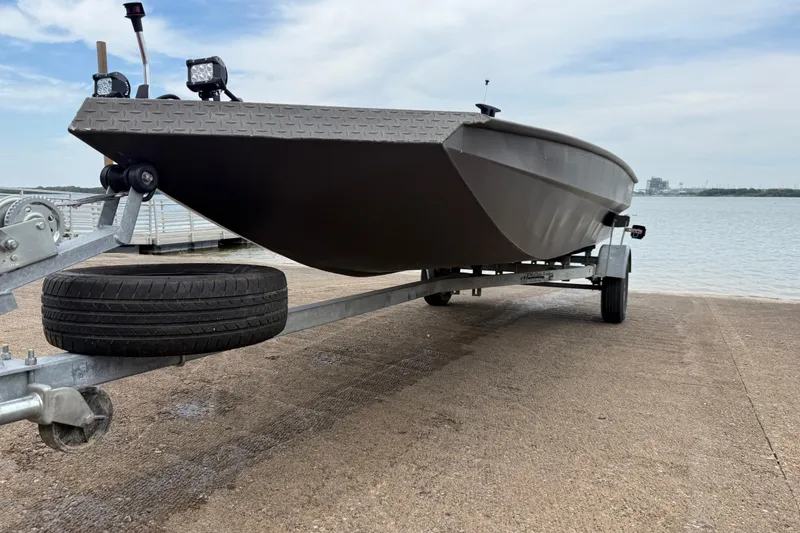 Slide: The Image of 2021 Alweld 1852 Invader boat on trailer by the water. - 3