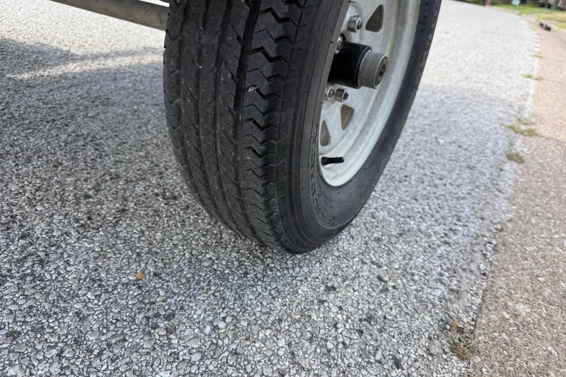 Slide: The Image of Close-up of a 2021 Alweld 1852 Invader trailer tire on a gravel road. - 30