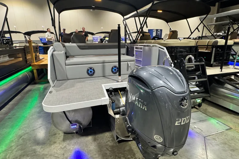 Slide: The Image of 2026 Veranda Relax VR235VL pontoon boat with Yamaha 200 engine displayed indoors. - 12