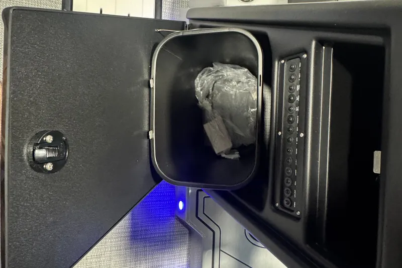 Slide: The Image of Open storage compartment in 2026 Veranda Relax VR235VL boat, featuring control panel and interior lighting. - 6